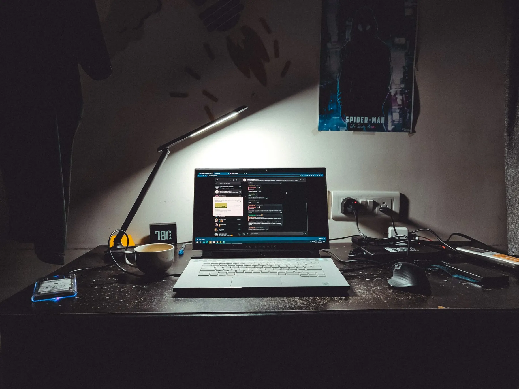 A desk with a laptop, in soft, warm light